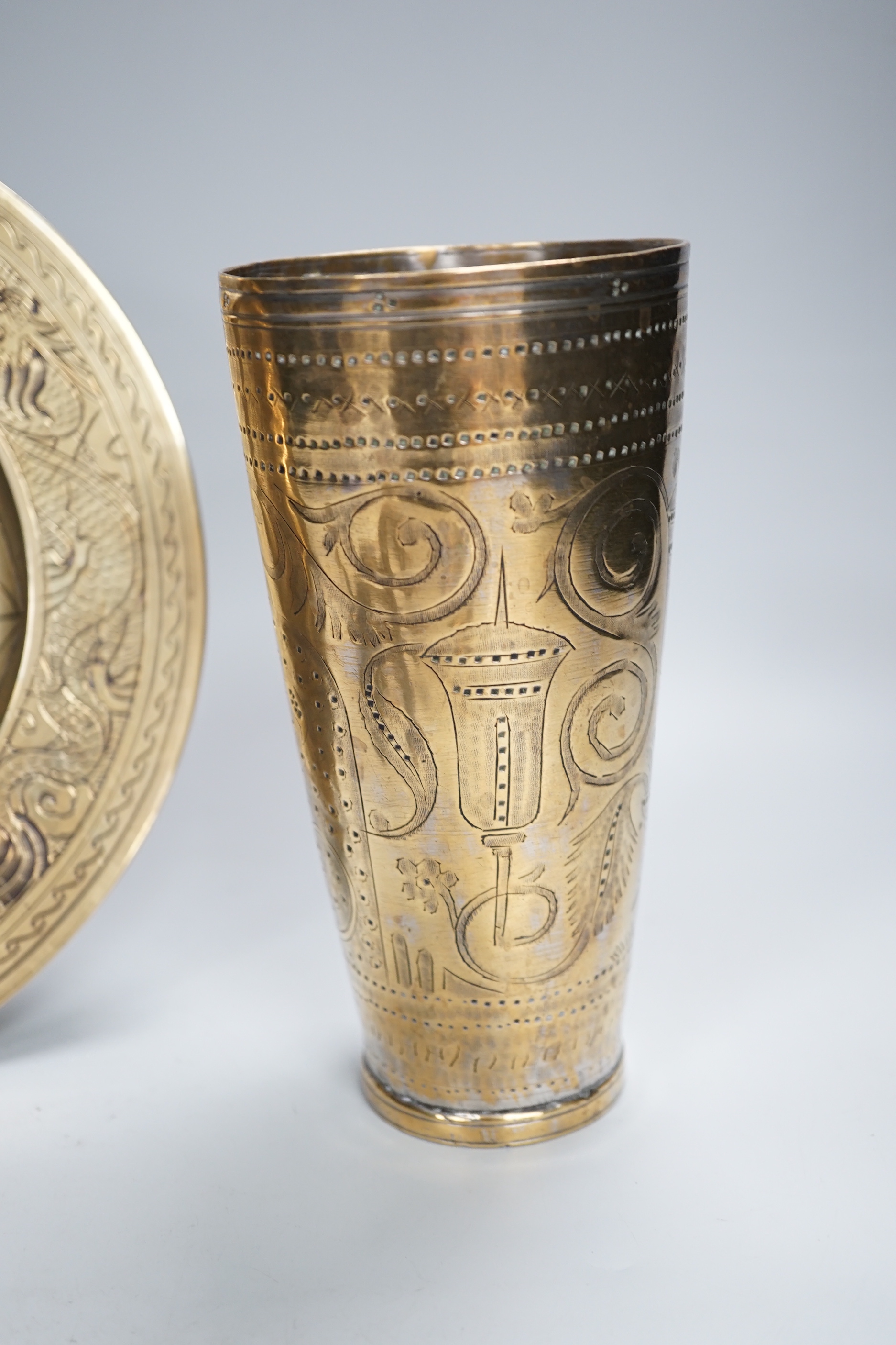 A Chinese engraved brass plate, large engraved beaker, koi fish and a dragon, the largest 24cm in diameter